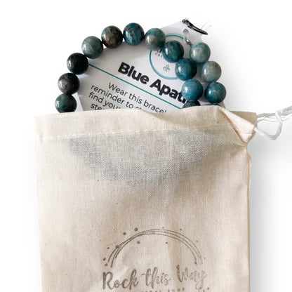 Blue apatite bracelet on a branded card over a 'Rock this Way' pouch