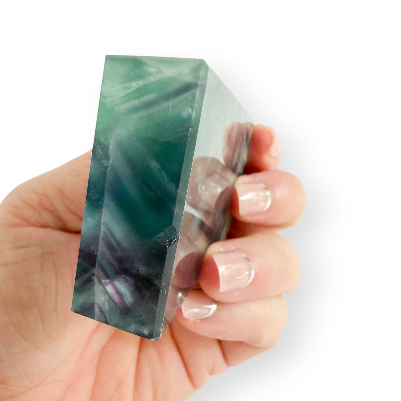 Large Rainbow Fluorite crystal tower with vibrant green and purple banding and translucent layers showing natural imperfection.