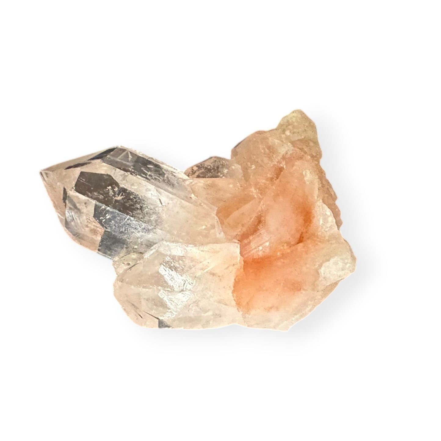 Clear quartz crystal with orange mineral tinted base on white background
