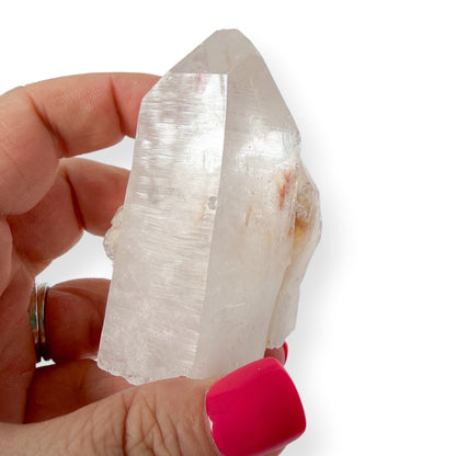 Clear quartz in hand with twin points for reference and size