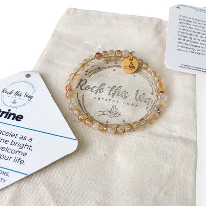 Citrine crystal bracelet with packaging on a white background ready to gift.
