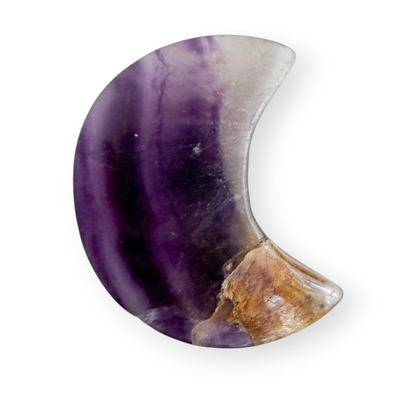 Polished purple fluorite crescent moon crystal carving featuring deep purple banding and natural mineral inclusions.