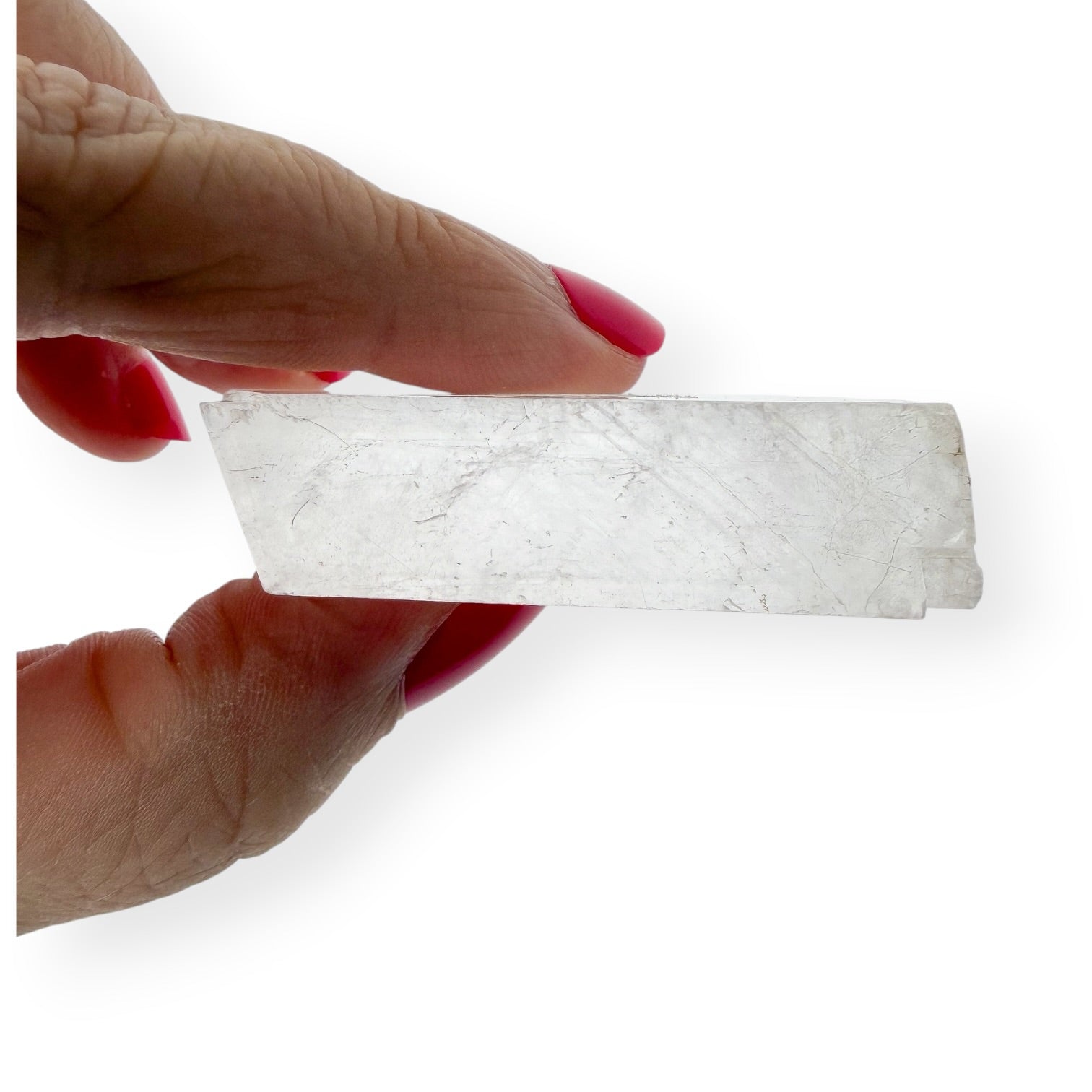 Side view in hand of the clear icelandic spar