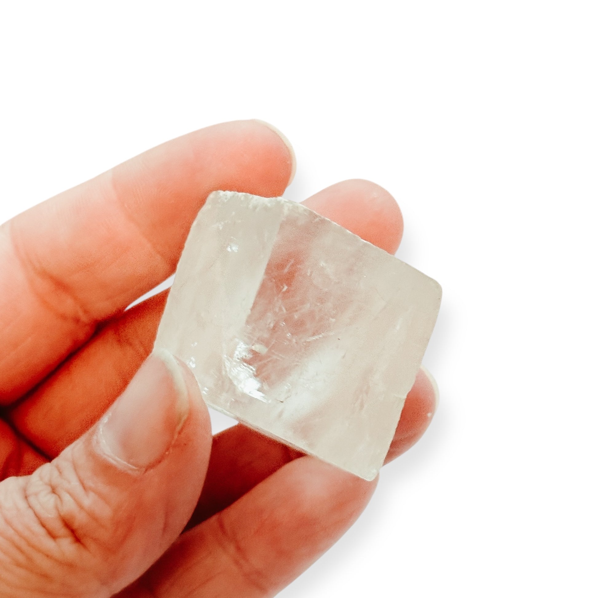 Clear Optical Calcite crystal held in hand, showing size and clarity