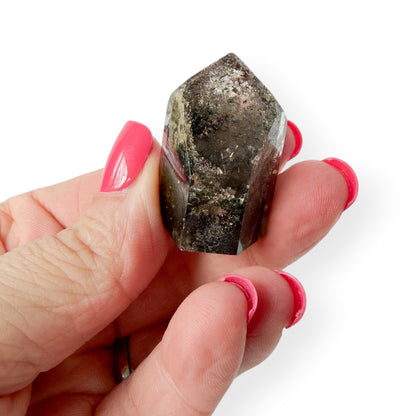 Lodolite garden quartz in hand to show details and size