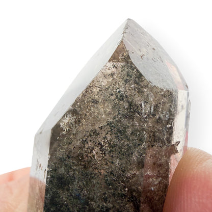 Lodolite quartz close up of the point with small scratches/chips. 
