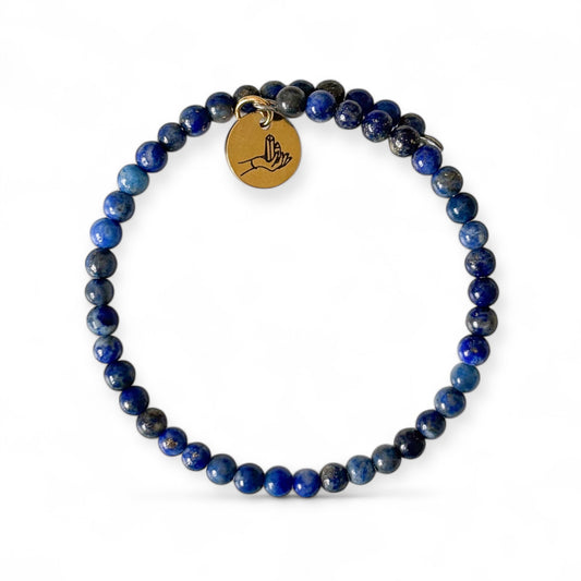 Lapis Lazuli Wrap Bracelet with gold-flecked deep blue beads on white background