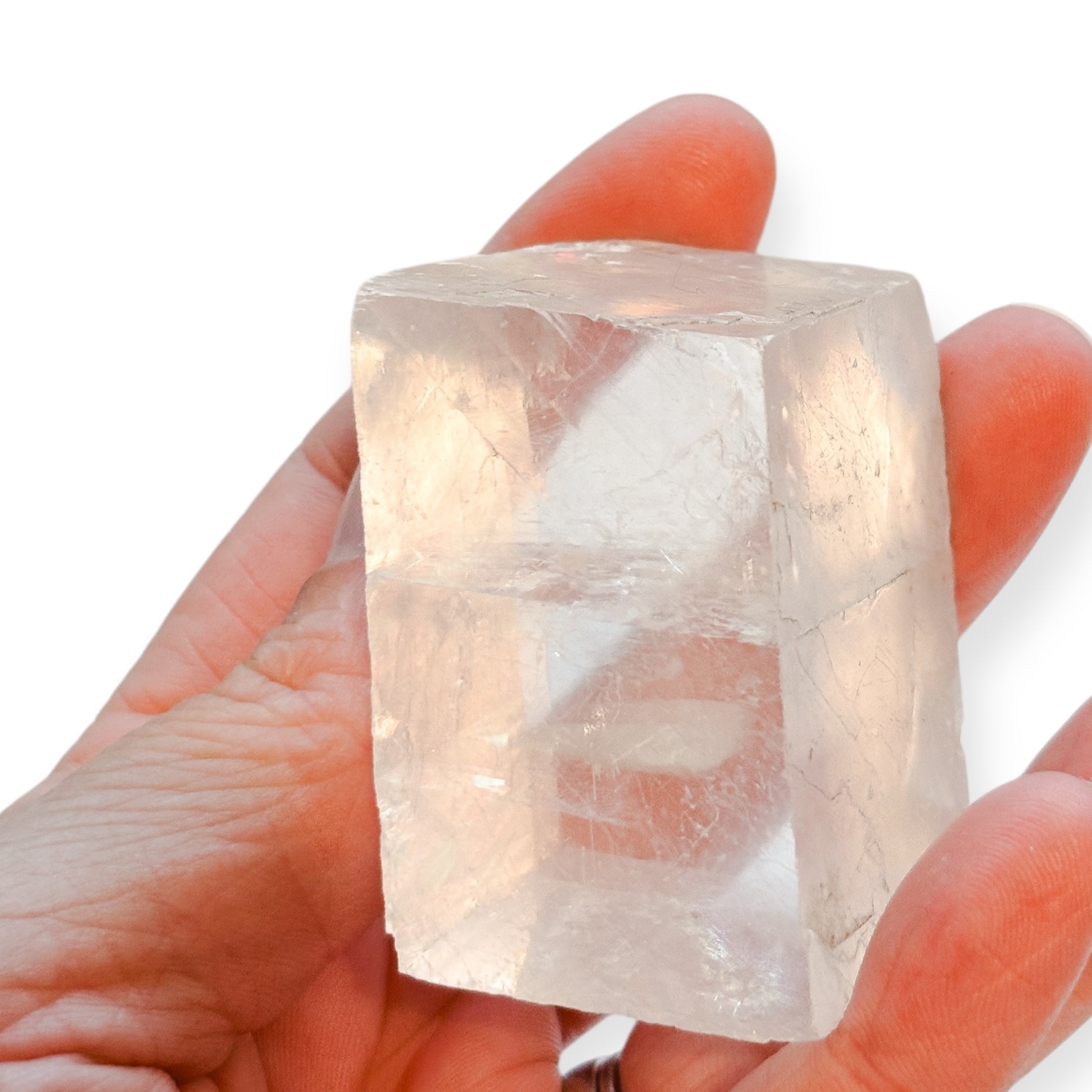 Clear Optical Calcite crystal in hand showing its large size
