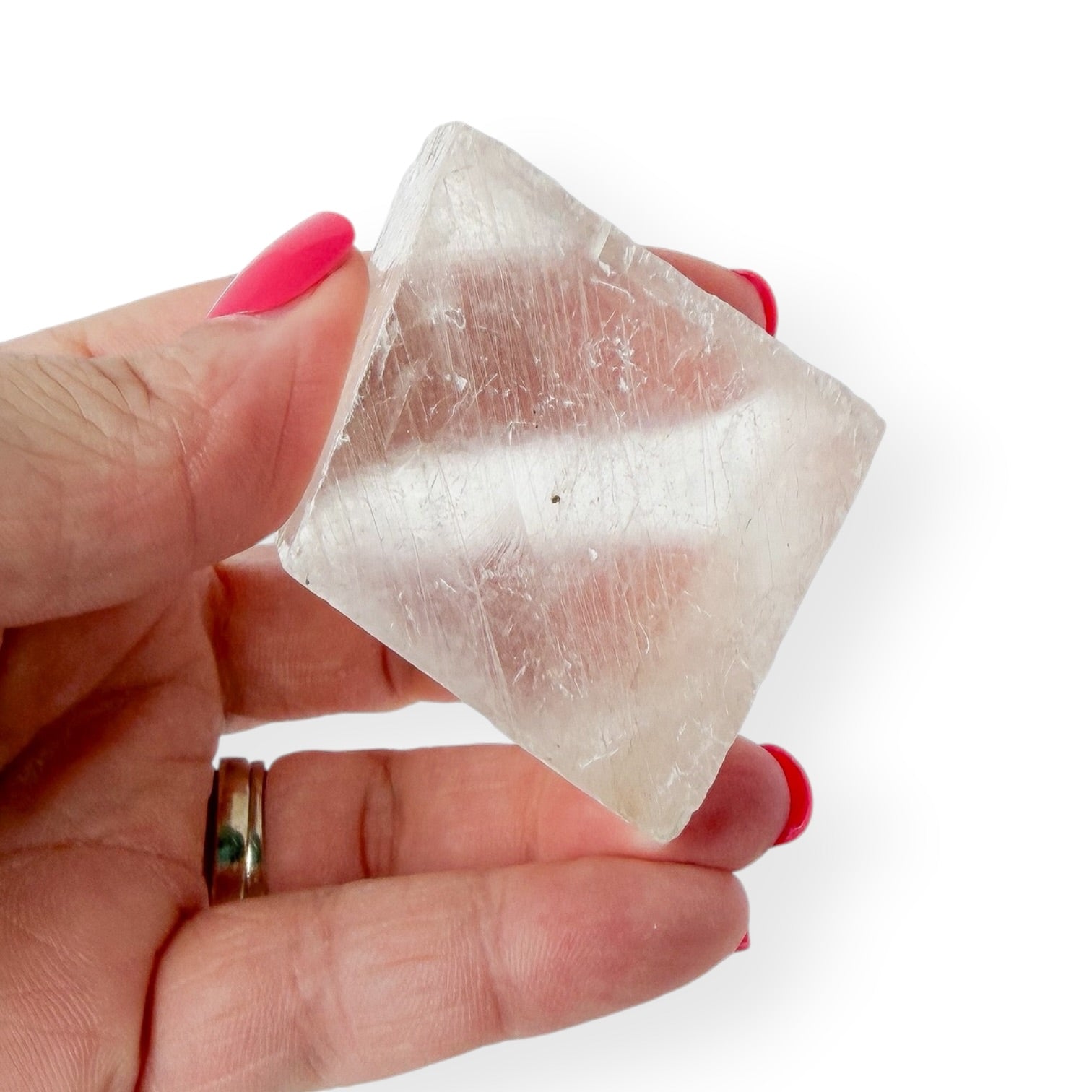 Icelandic spar in hand with slight translucency.