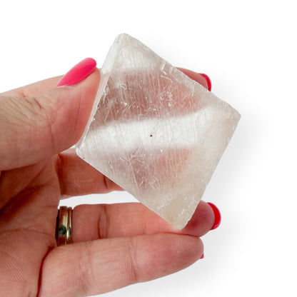 Icelandic spar in hand with slight translucency.