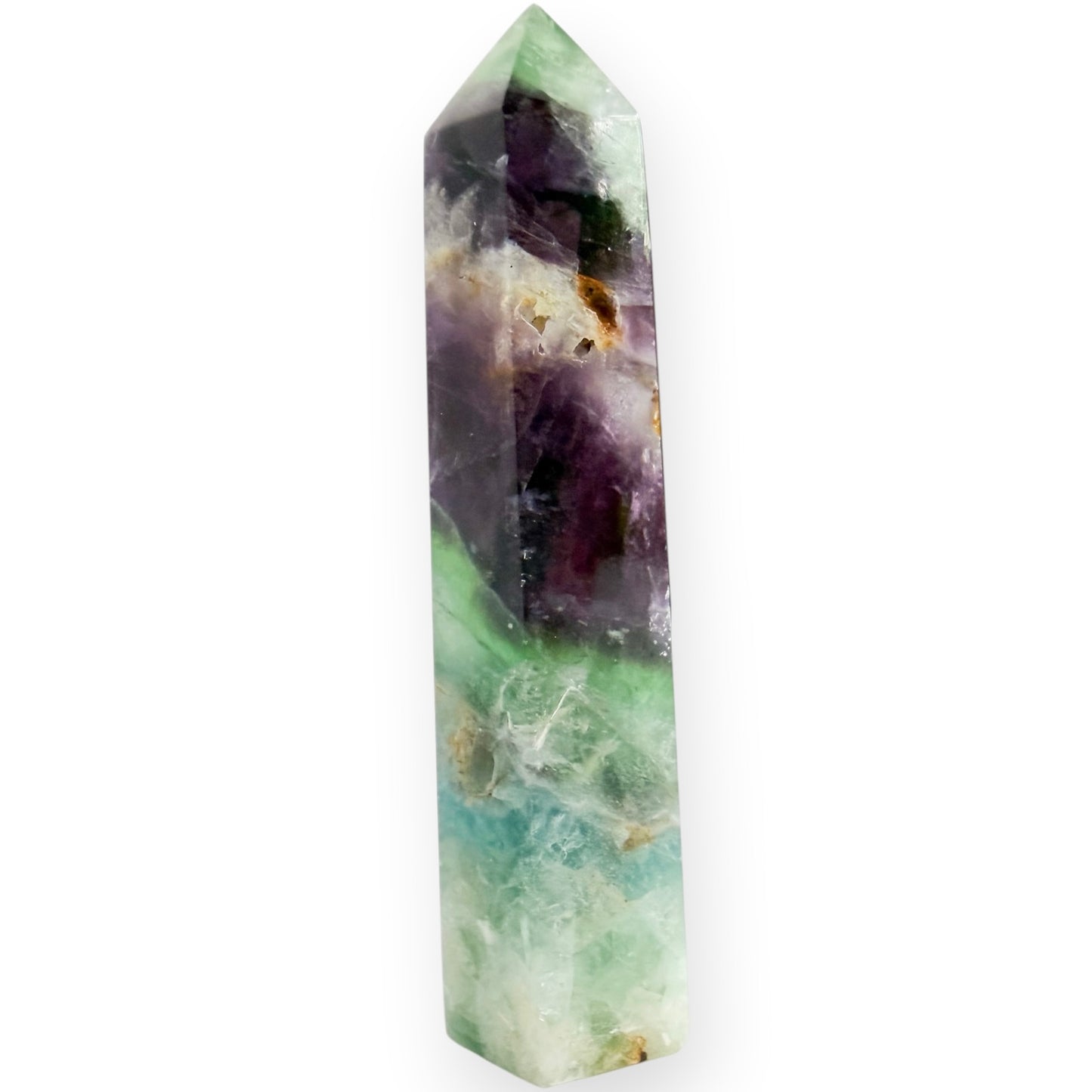 A purple and green fluorite obelisk on a white background with a drusy accent.