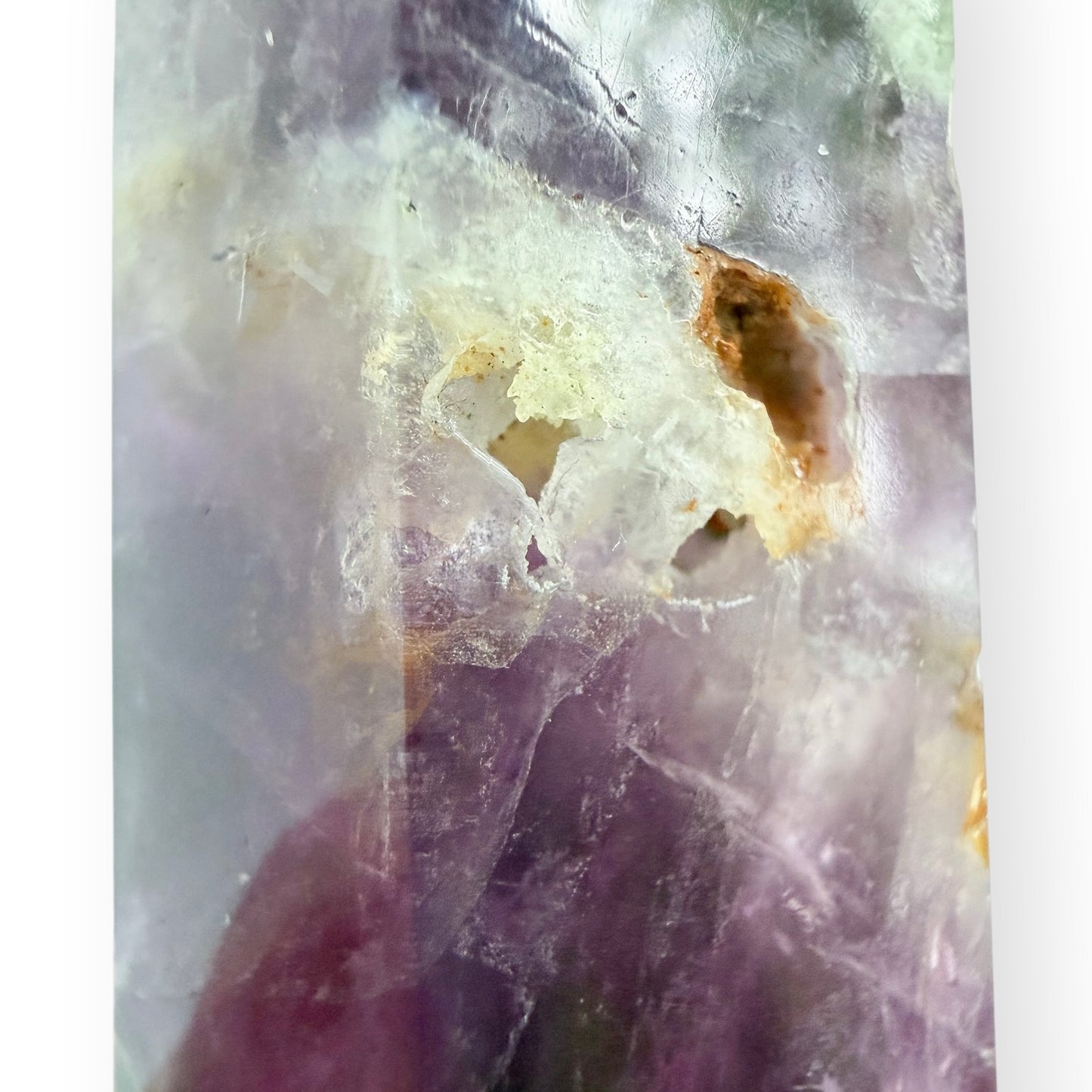 Close-up of a purple and green fluorite obelisk to show drusy accent.