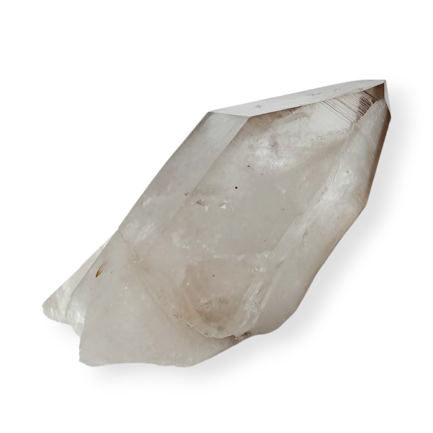 Side view of a clear quartz point on a white background.