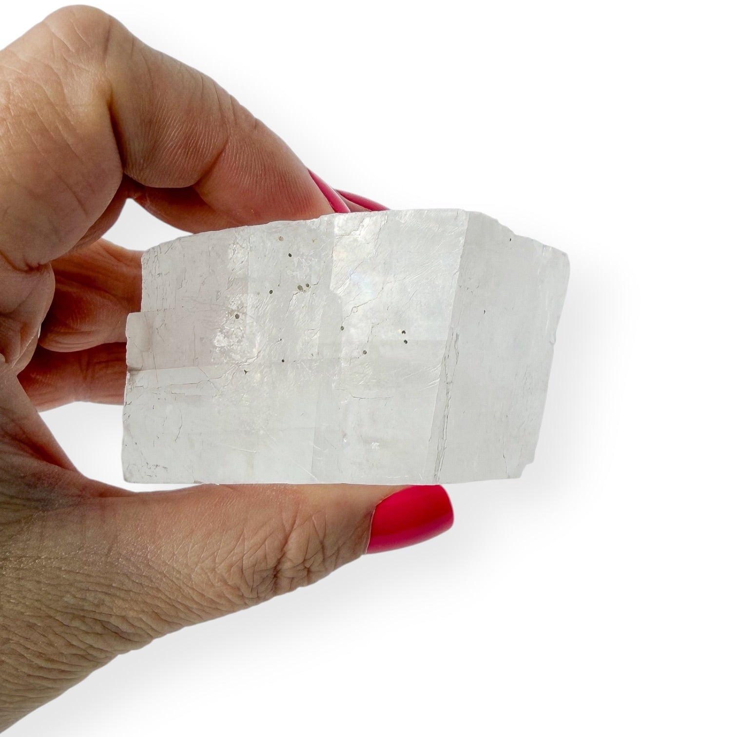 Side view of optical calcite in hand (Icelandic spar)