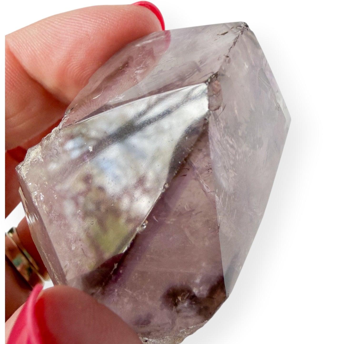 Small Amethyst Close Up Chipped Point in hand with a white background
