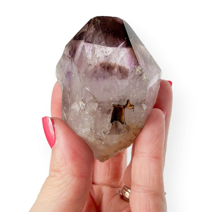 Small Amethyst point in hand to show size and detail.