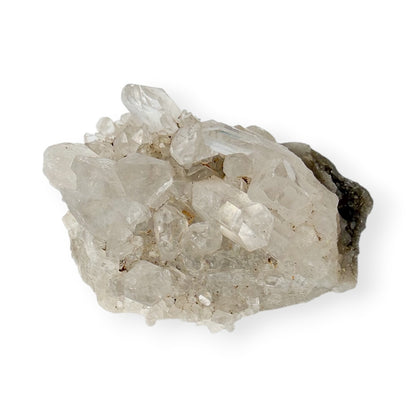 Small clear, quartz, cluster, and matrix with a white background