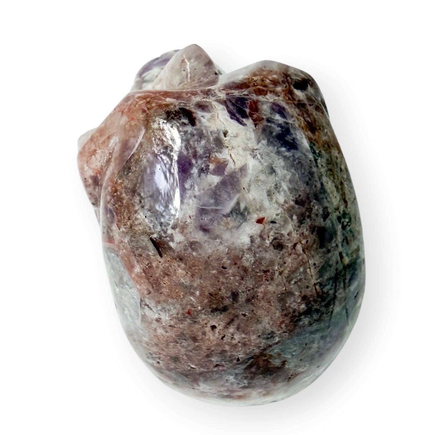 Top view of a light Lepidolite hand carved skull with a white background.