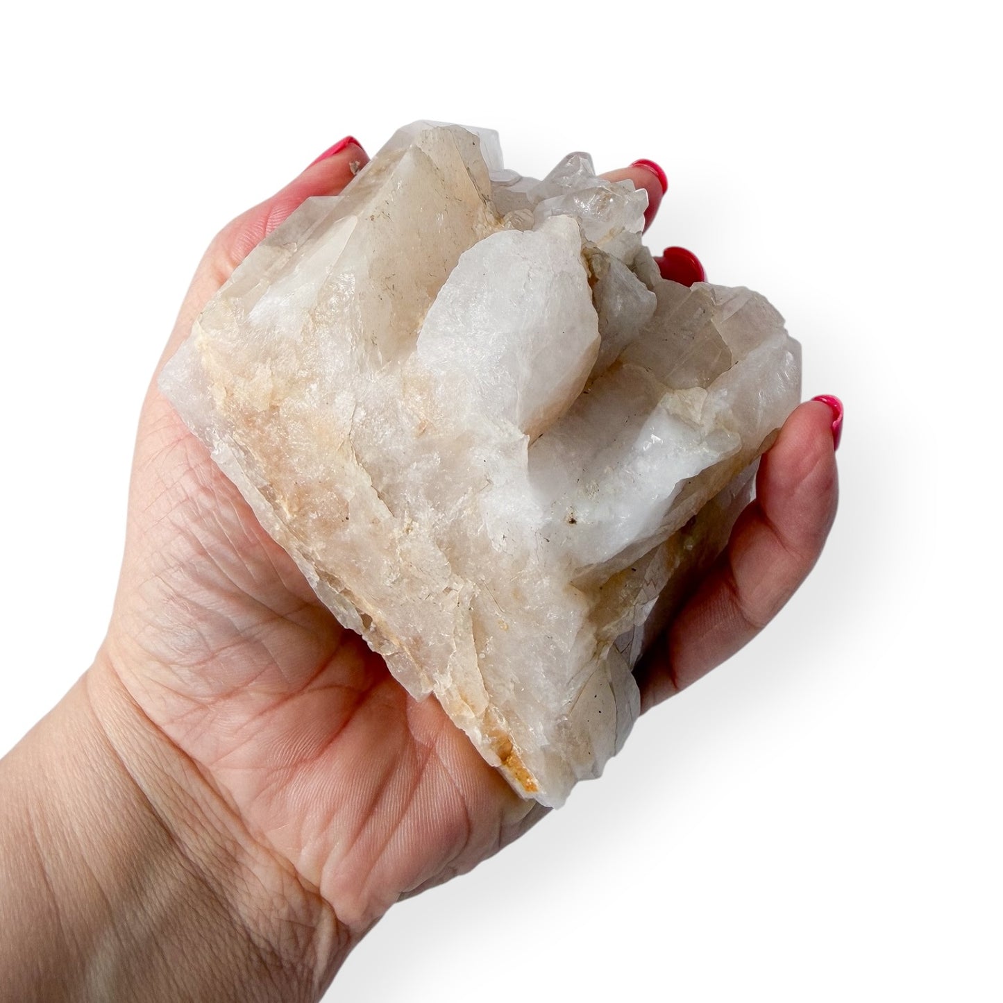 Hand holding a large crystal rock against a white background