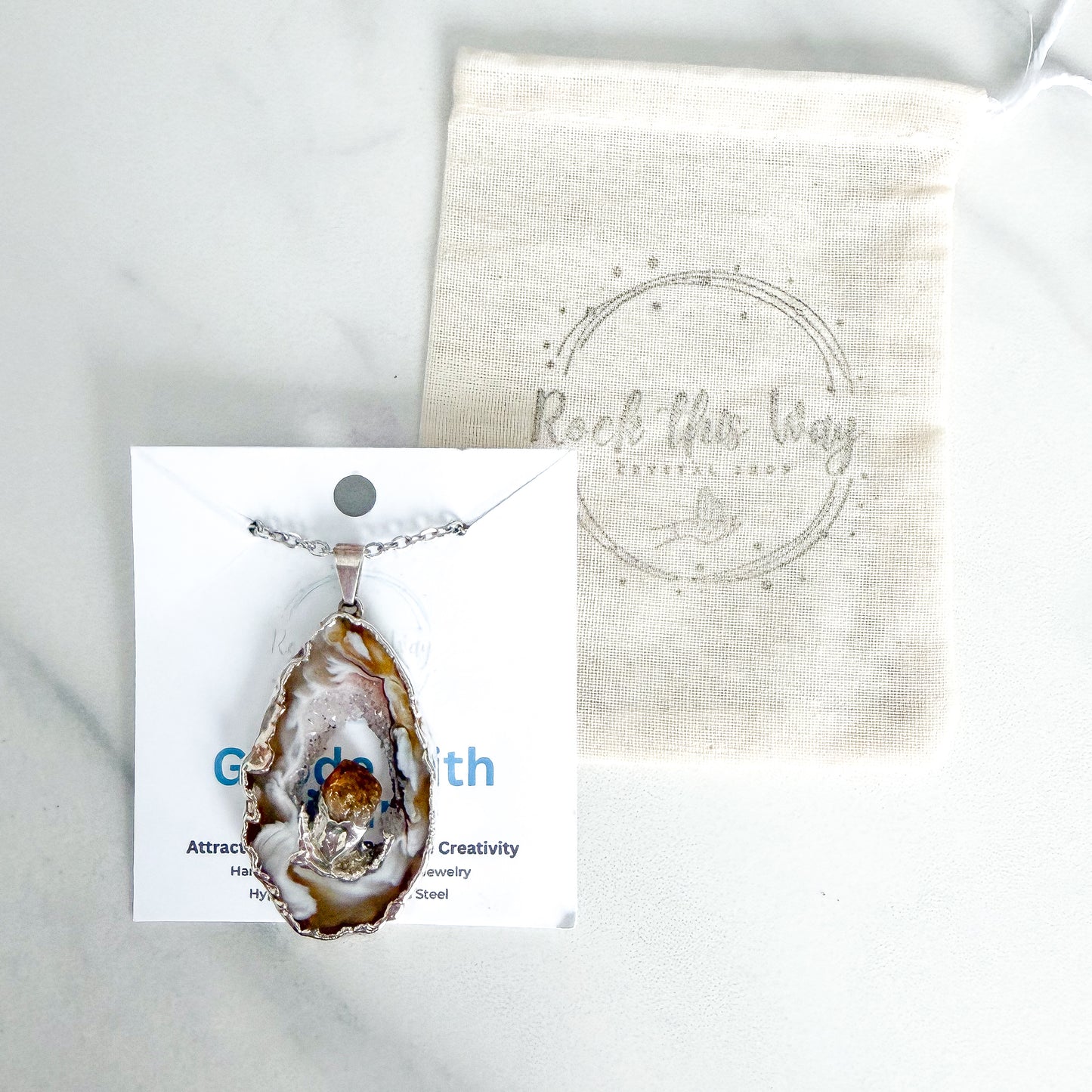 Agate geode slice pendant necklace with citrine crystal packaged for gifting on stainless steel chain