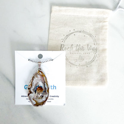 Agate geode slice pendant necklace with citrine crystal packaged for gifting on stainless steel chain