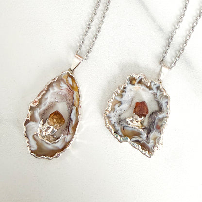 Two silver plated agate geode slice pendant necklaces with natural citrine crystals on stainless steel chains