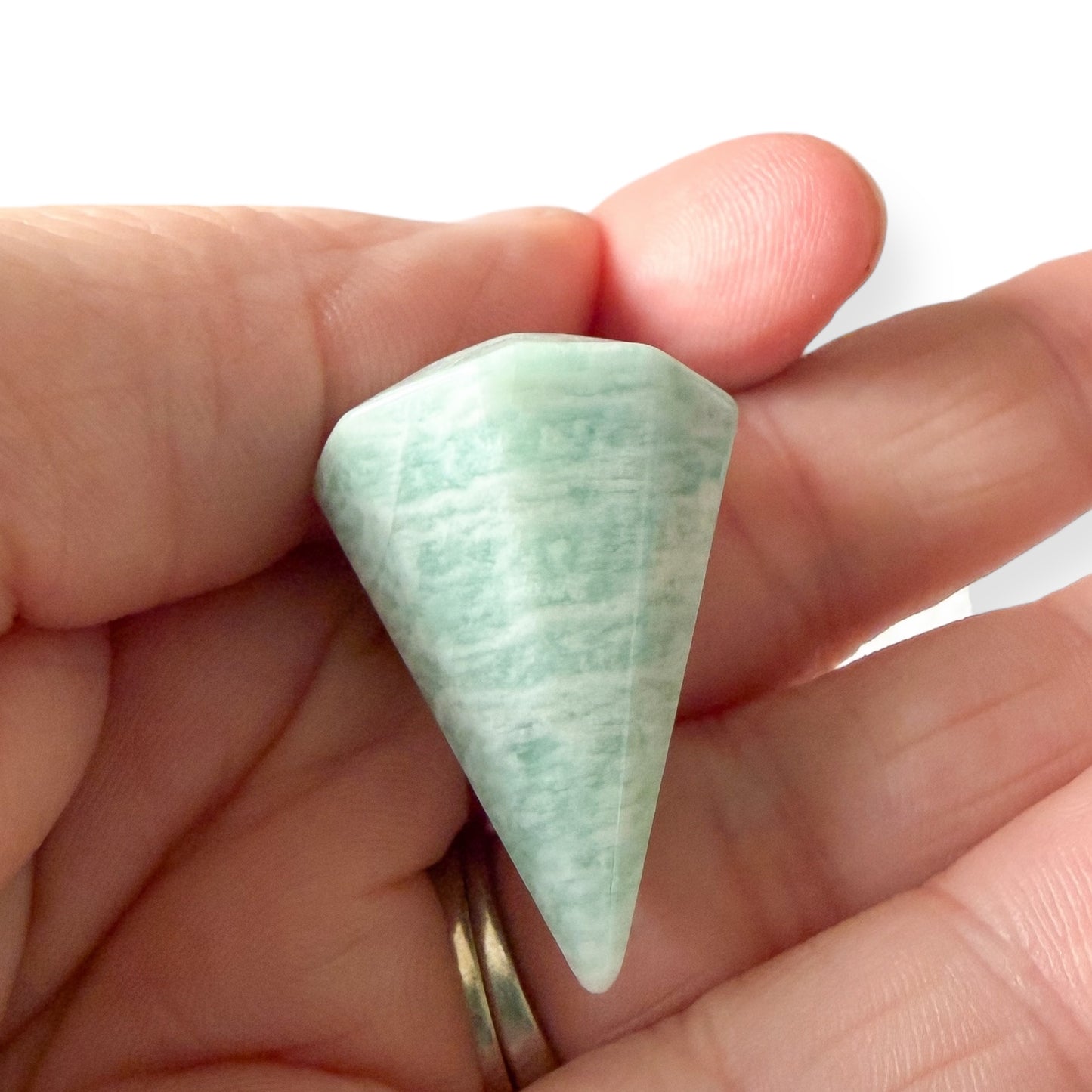 Close up of amazonite crystal pendulum metaphysical spiritual divination tool
