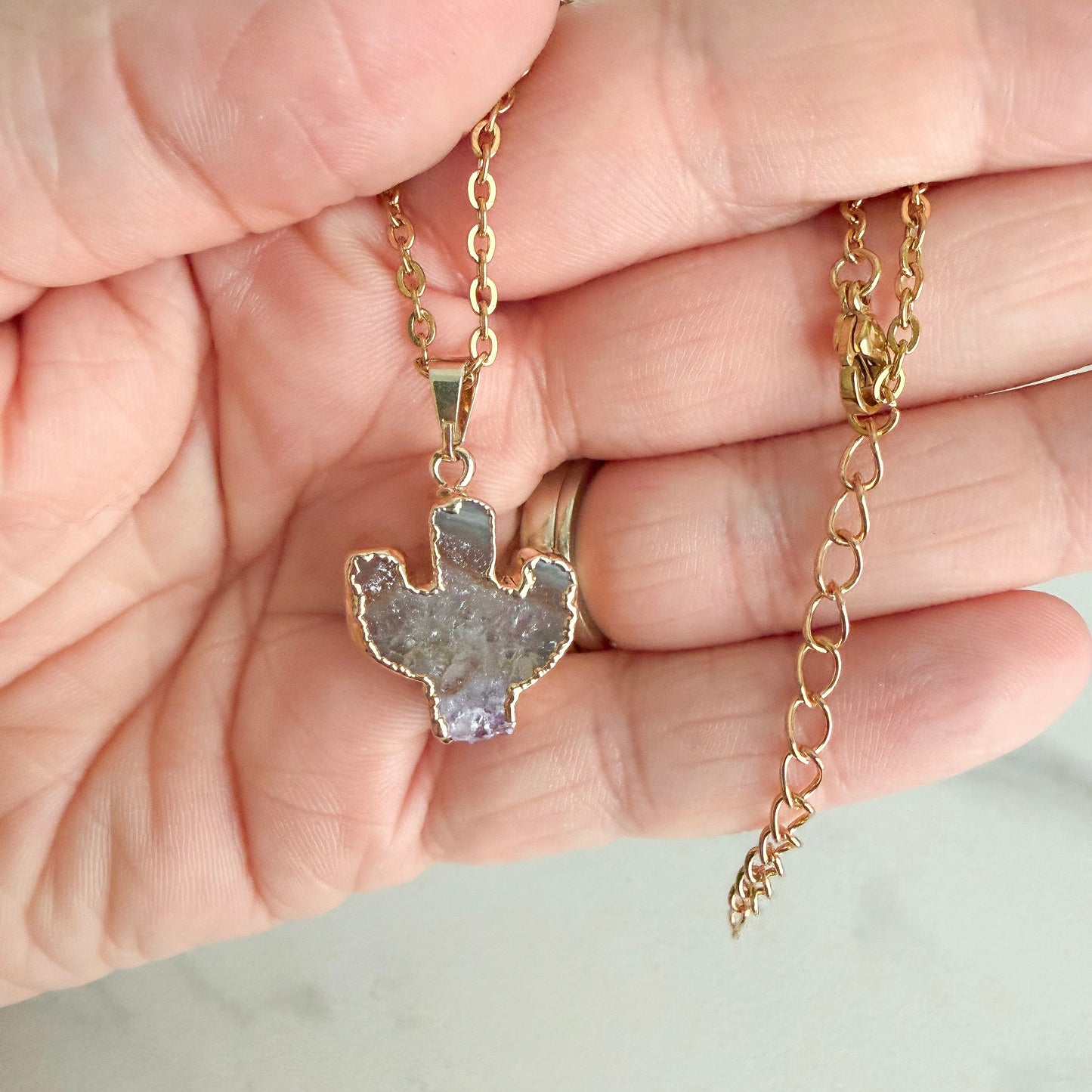 Gold plated stainless steel necklace with adjustable extender and natural amethyst cactus crystal pendant.