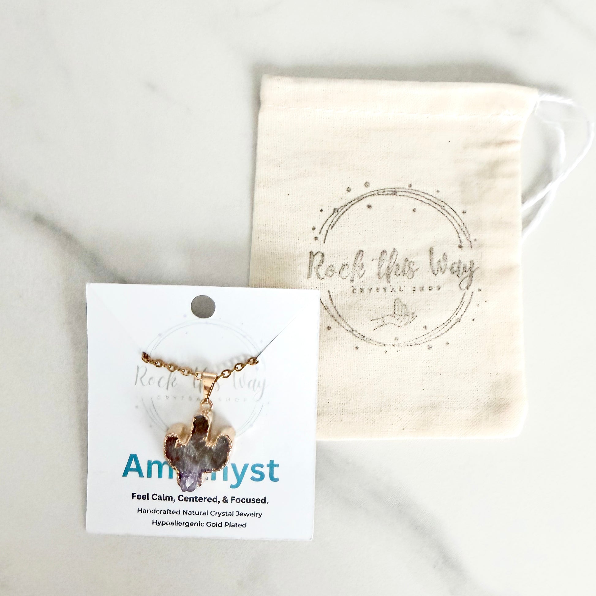 Amethyst cactus pendant necklace with lavender and purple crystal tones displayed on Rock This Way Crystal Shop packaging with gold plated chain.