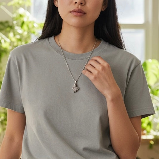 Modeled view of an amethyst cactus pendant necklace with silver plated setting on a stainless steel chain, shown in an AI generated lifestyle image.
