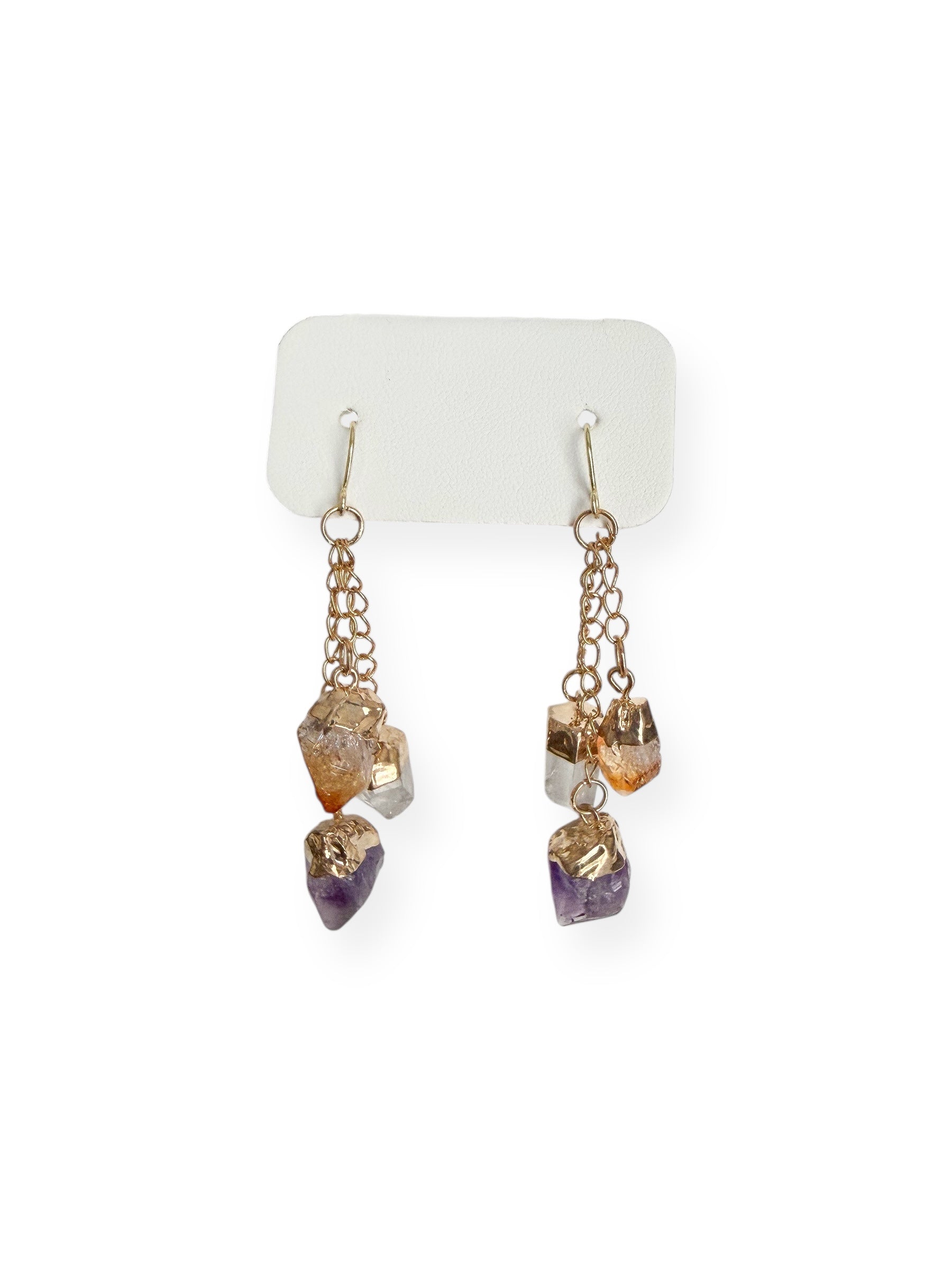 Close-up of gold plated dangle earrings featuring raw amethyst, citrine, and clear quartz crystals