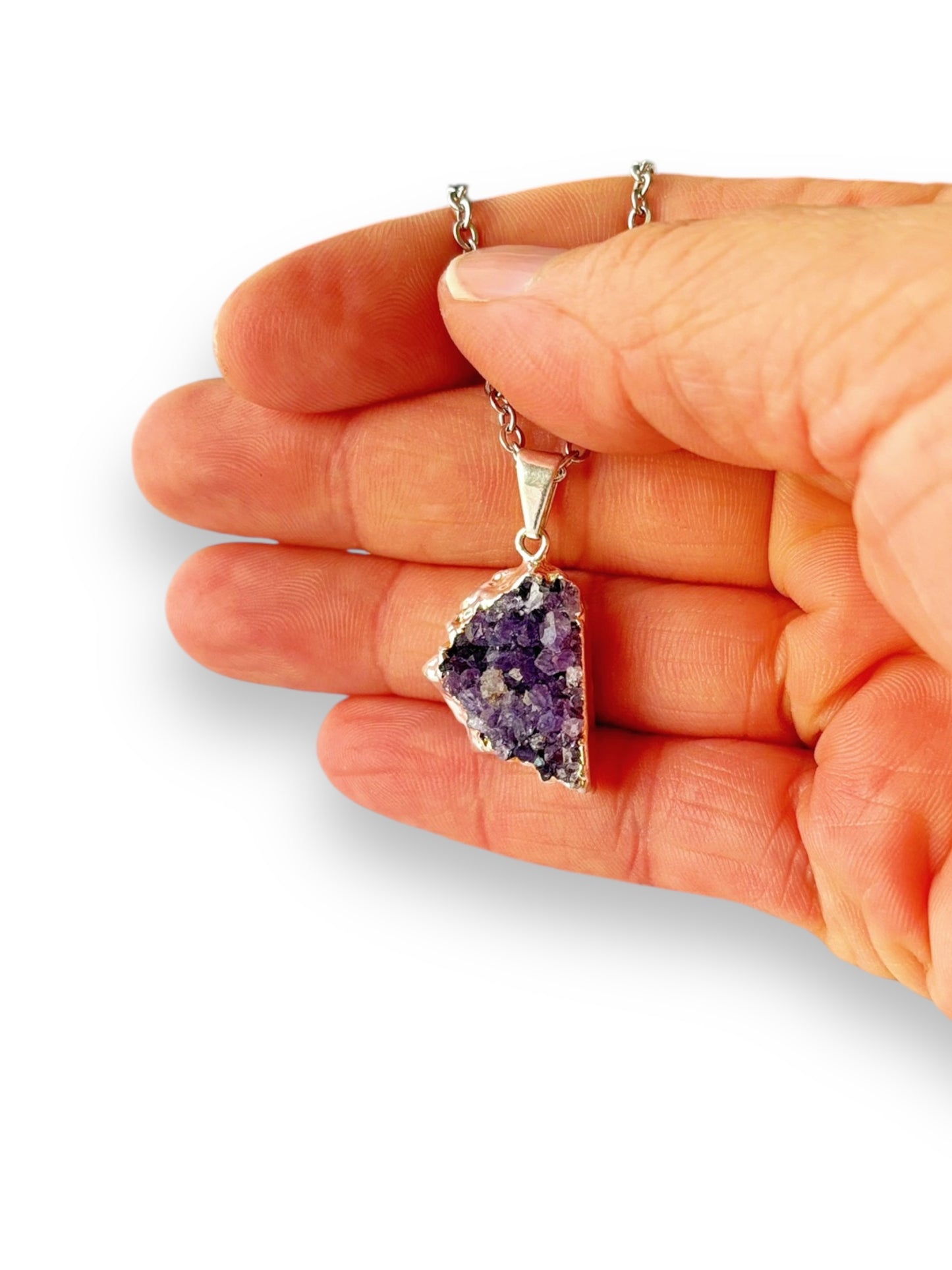 Amethyst drusy necklace glowing in natural light with visible purple points