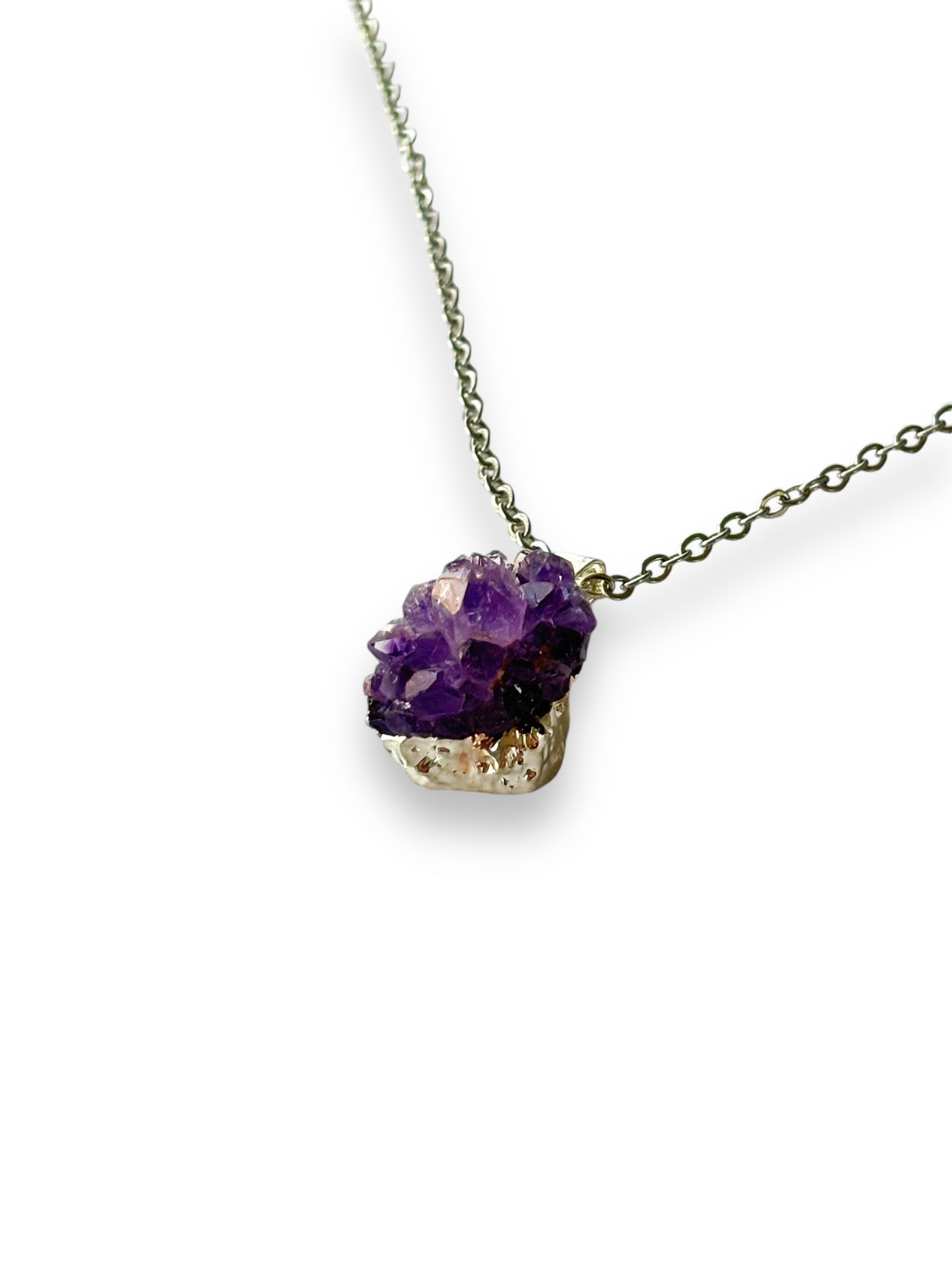 Amethyst drusy necklace laid flat showing pendant and stainless steel chain