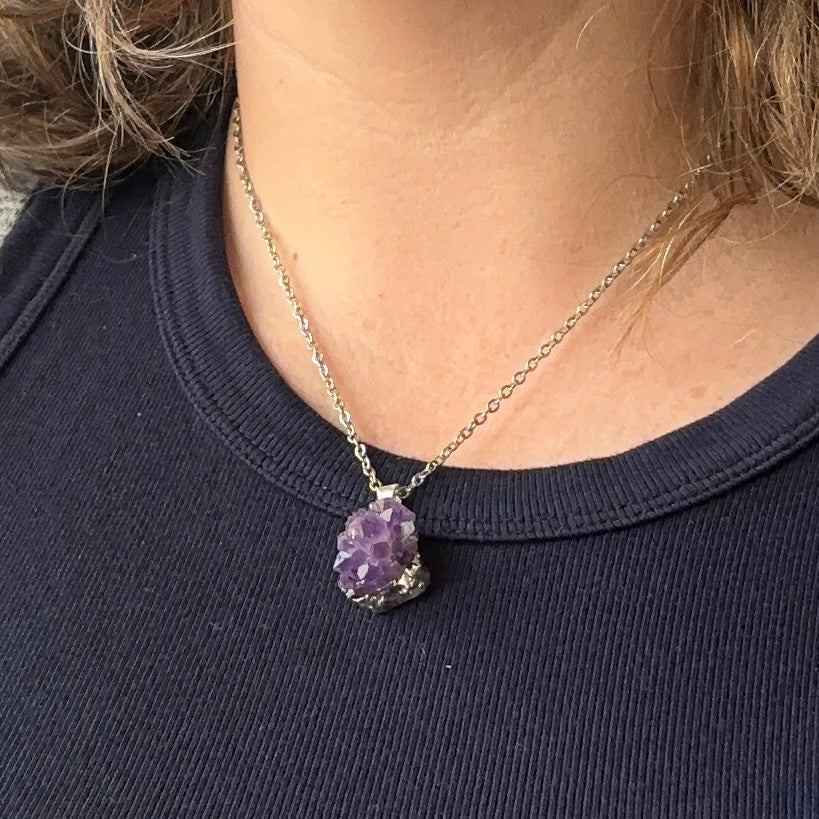Amethyst drusy necklace worn on an 18-inch stainless steel chain, styled on a person