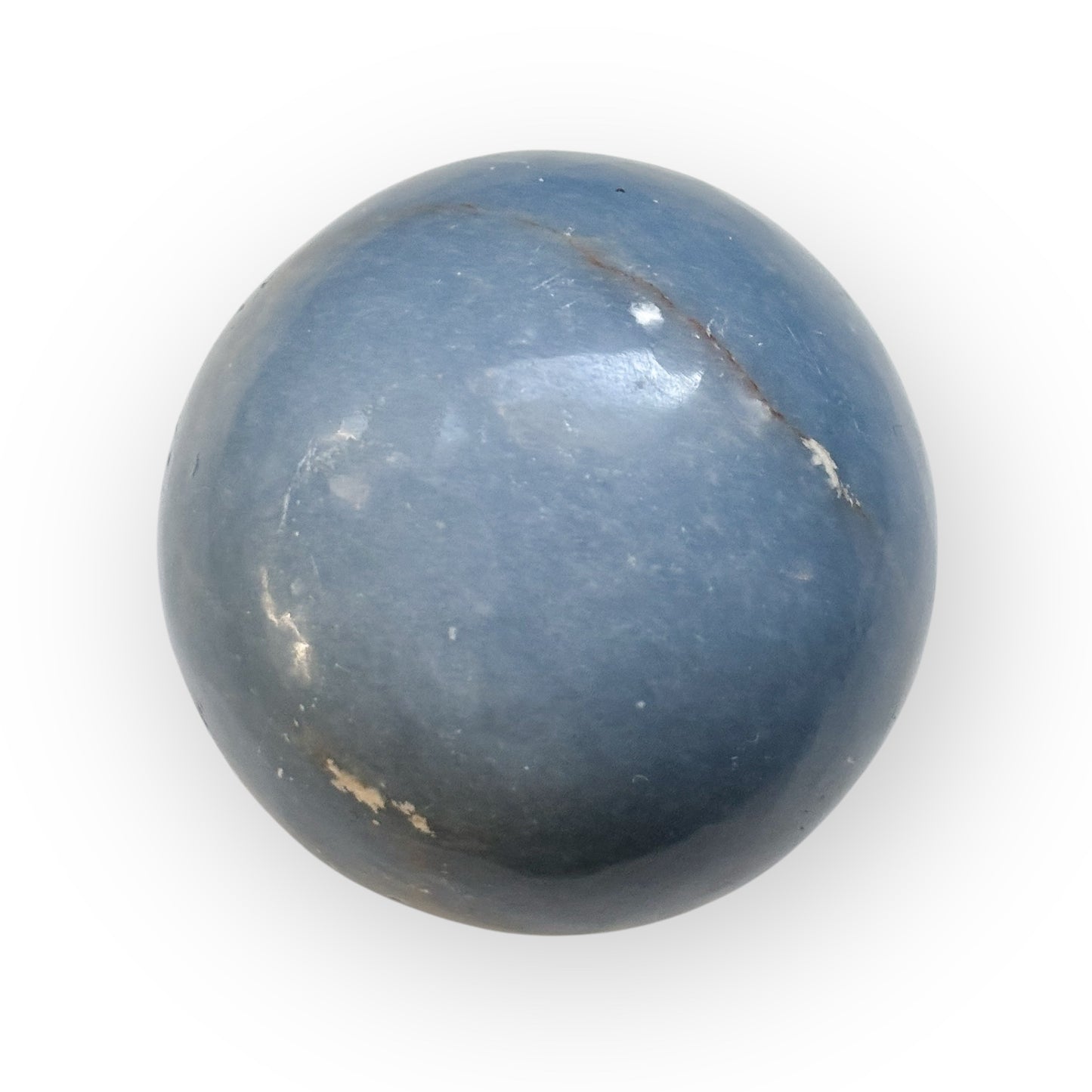 Side view of Angelite crystal sphere with natural shimmer