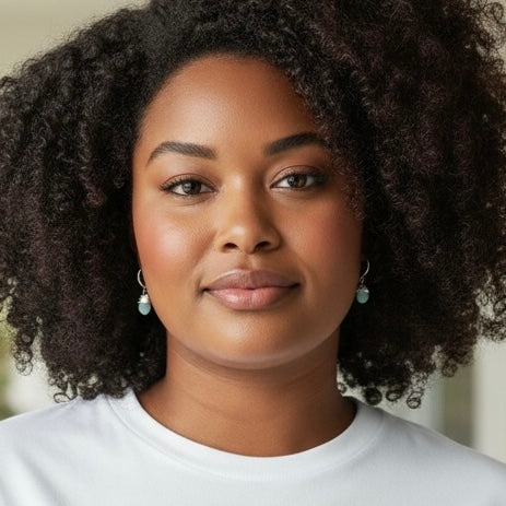 Aquamarine drop huggie earrings worn on model, white gold filled hoops with light blue aquamarine stones
