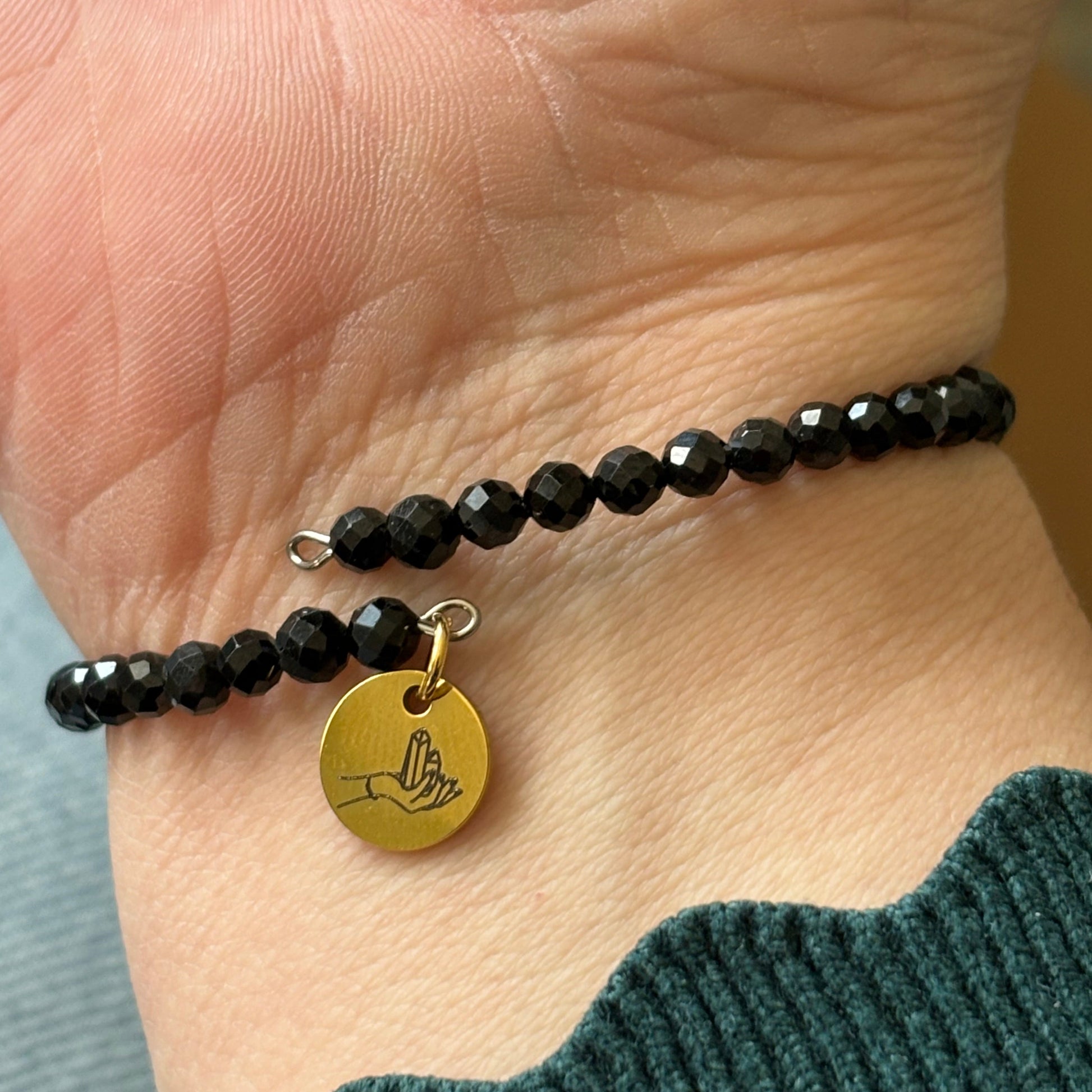 Black Tourmaline wrap bracelet sparkling in natural sunlight, symbolizing energy clearing and protection.