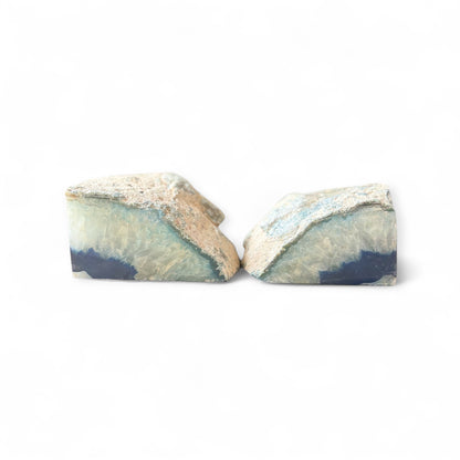Polished edge of tall blue agate bookends with shimmering crystal and deep navy center.