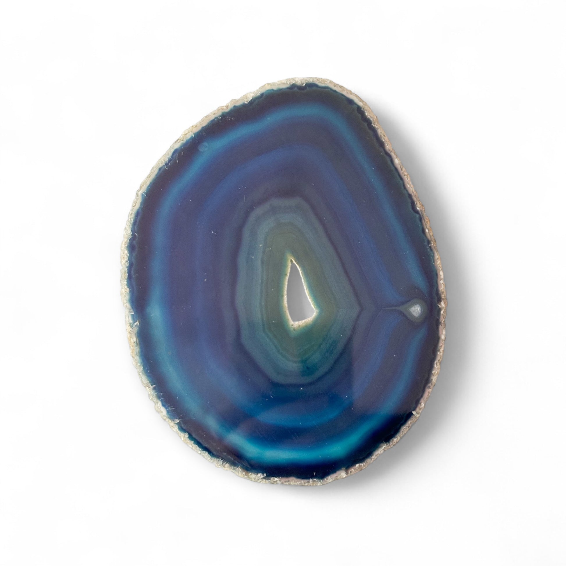 Blue agate slice with druzy pocket held in hand showing size and detail