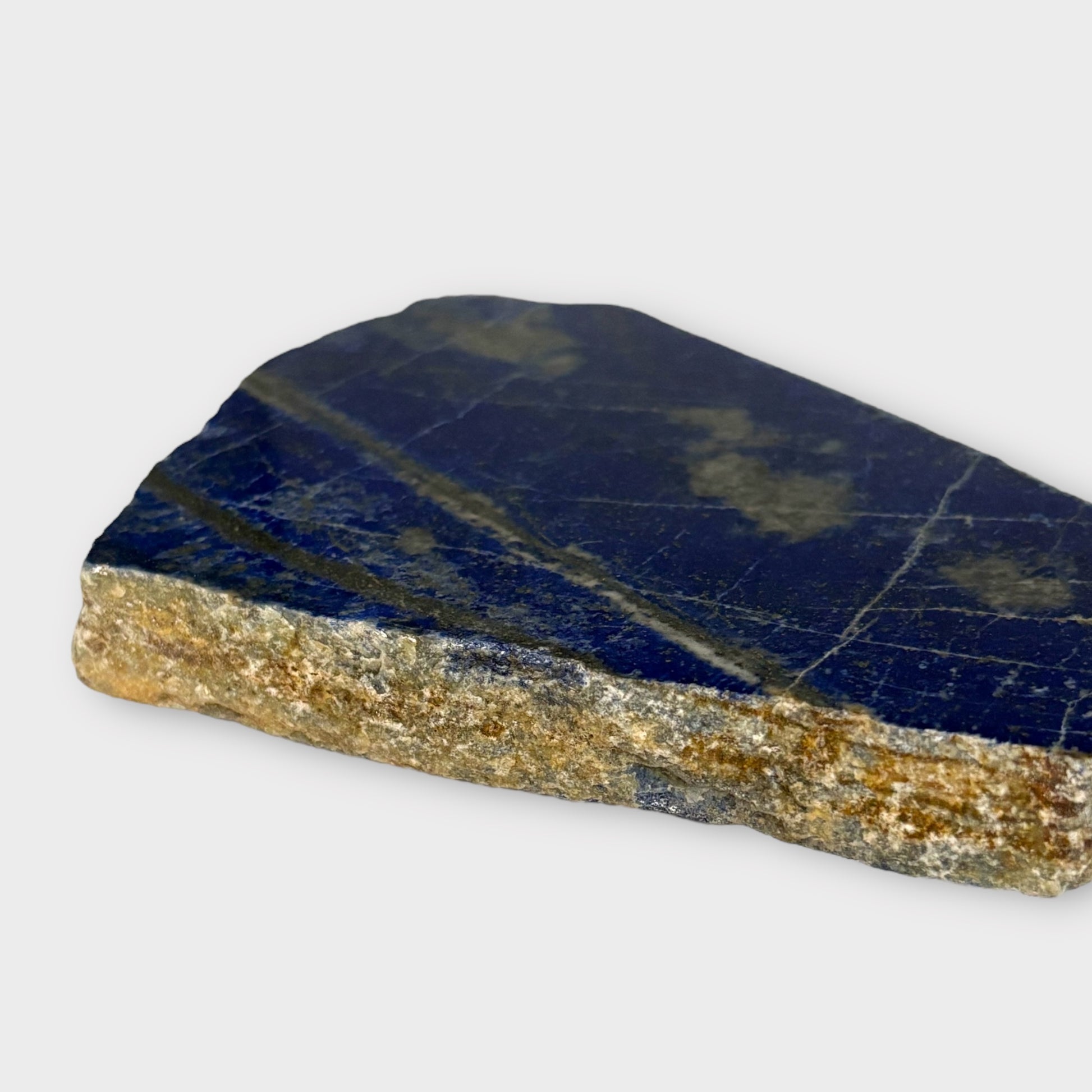 Close-up of Blue Lapis Lazuli crystal slab with white and gold streaks