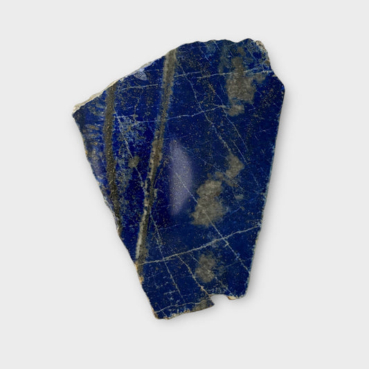 Blue Lapis Lazuli stone slab with polished surface and cloudy patterns