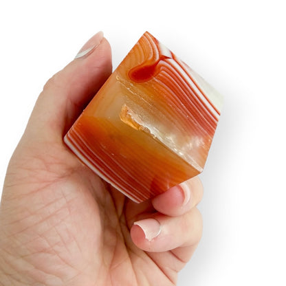 Handheld Carnelian Agate display cube featuring natural agate banding and a polished finish.
