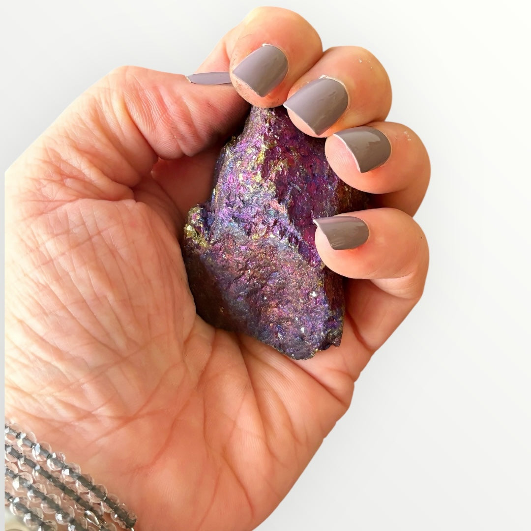 Raw Chalcopyrite Peacock Ore crystal held in hand showing vibrant texture