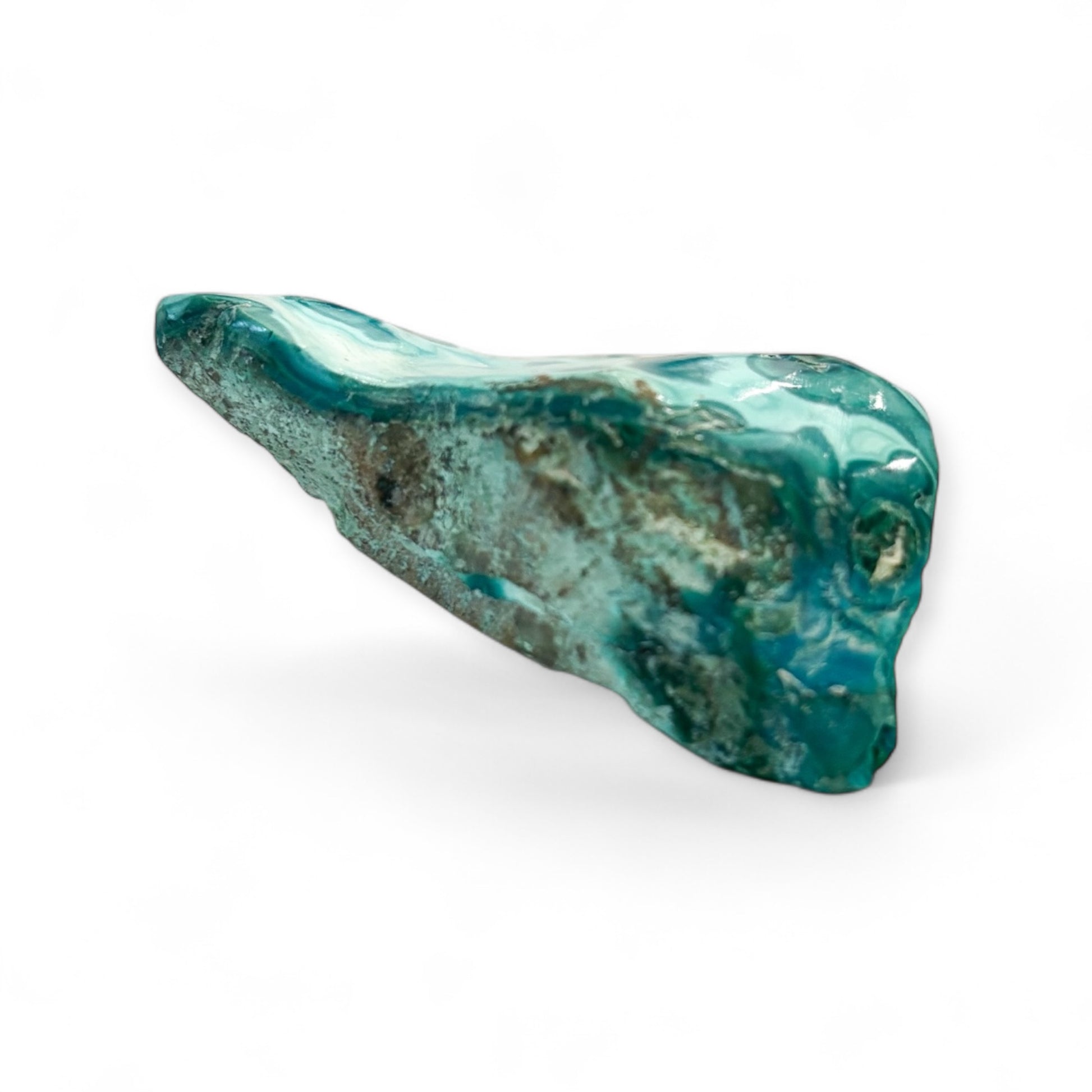 Side angle of polished Chrysocolla pocket stone showing teal swirls