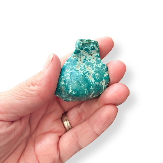 Hand holding Chrysocolla pocket stone with smooth, swirled blue-green surface