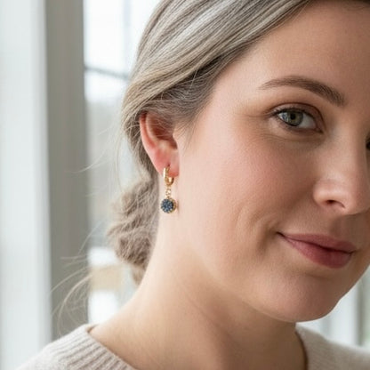 Circle drusy huggie earrings in gold filled worn on ear, featuring small round natural drusy crystal drops