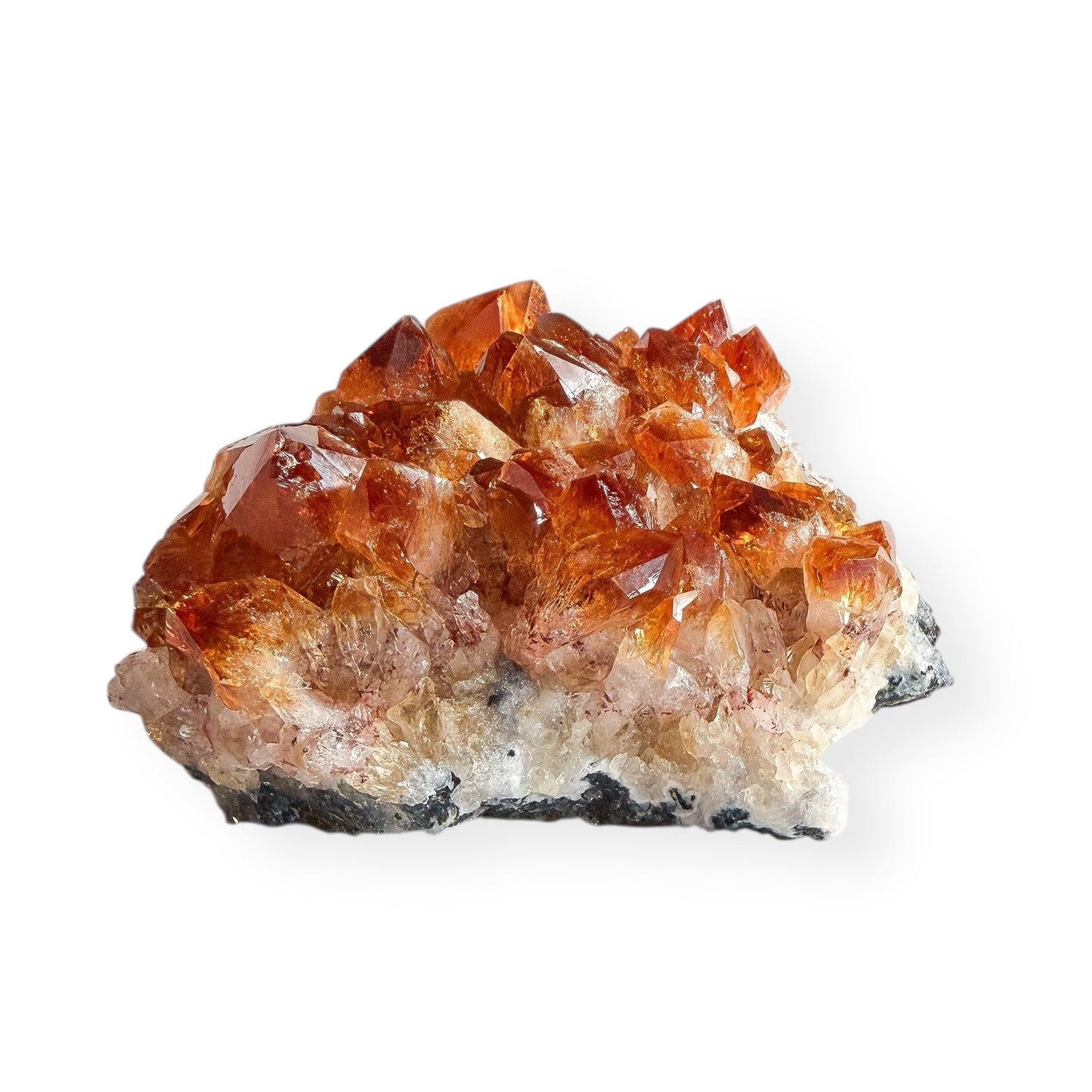 Heat-treated citrine cluster with golden crystal points on a white background.