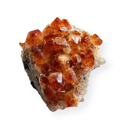Side view of citrine crystal cluster showing raw matrix base and crystal points.