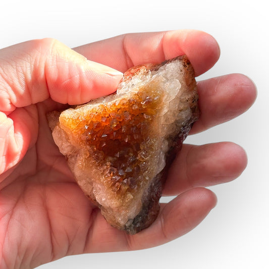 Raw Citrine Quartz Cluster held in hand, showing sparkling golden tips.