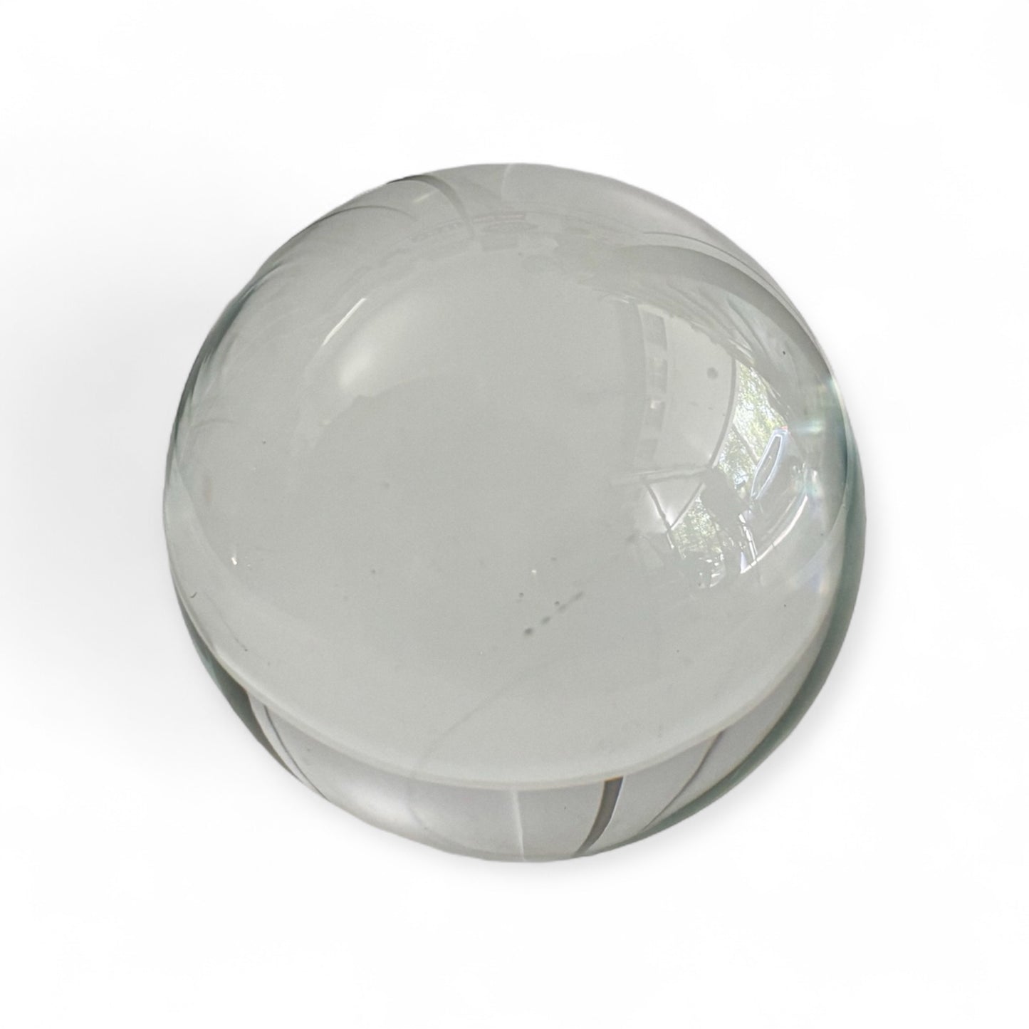 Close-up of a clear glass gazing ball showing smooth transparent surface
